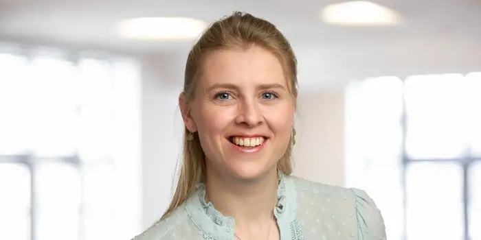 A young businesswoman smiles at the camera