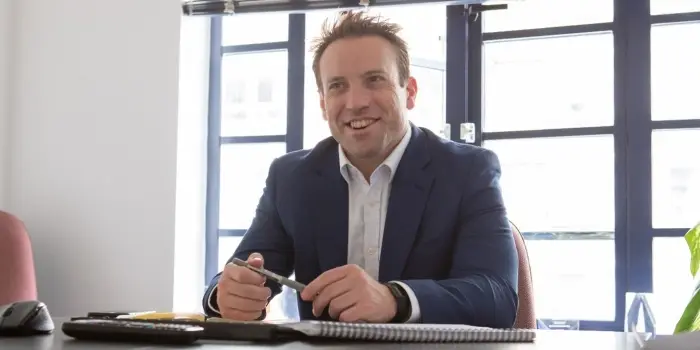 A photo of Ken Maxwell, director at John Lamb Hill Oldridge, at a desk.